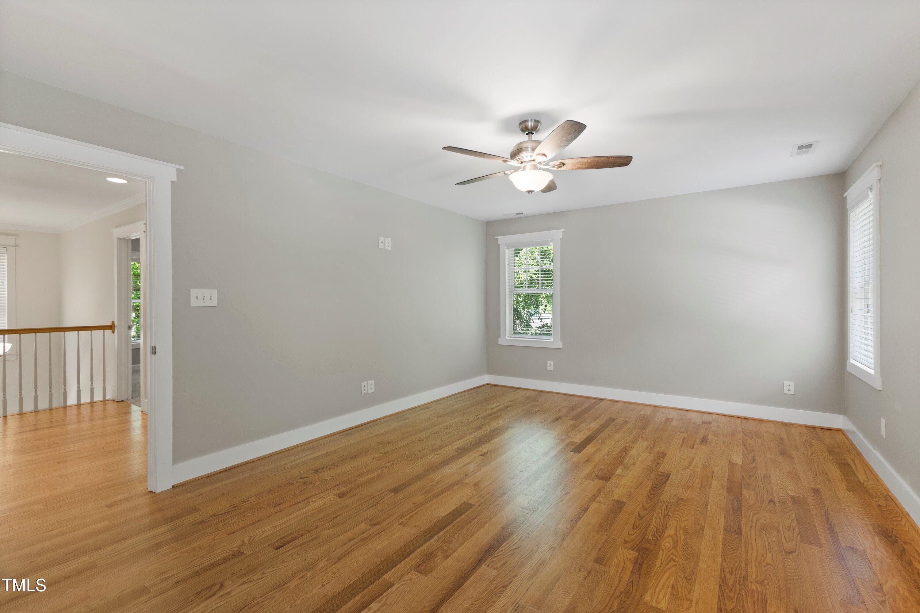 7408 Lakefall Drive Wake Forest, NC 27587 - Photo 29 of 65 an empty room with wooden floor and window