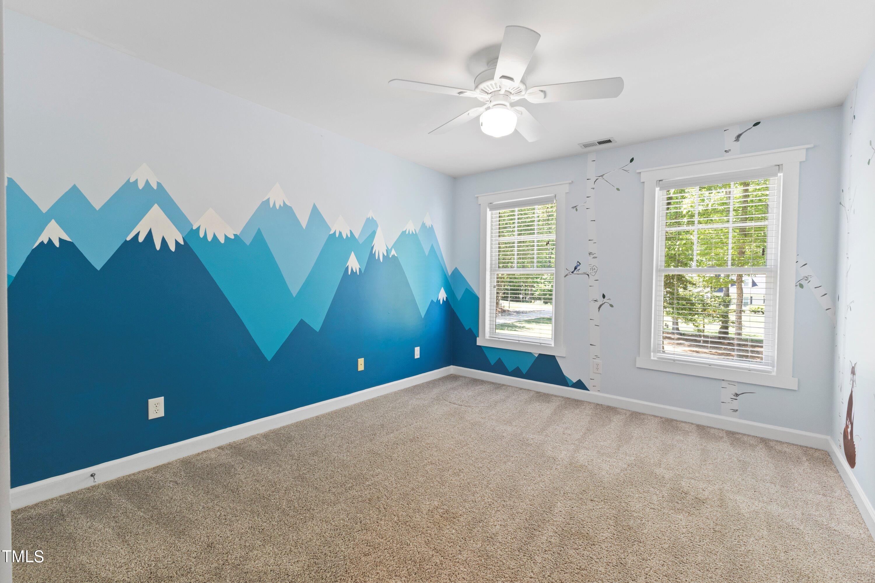 7408 Lakefall Drive Wake Forest, NC 27587 - Photo 37 of 65 an empty room with windows and fan