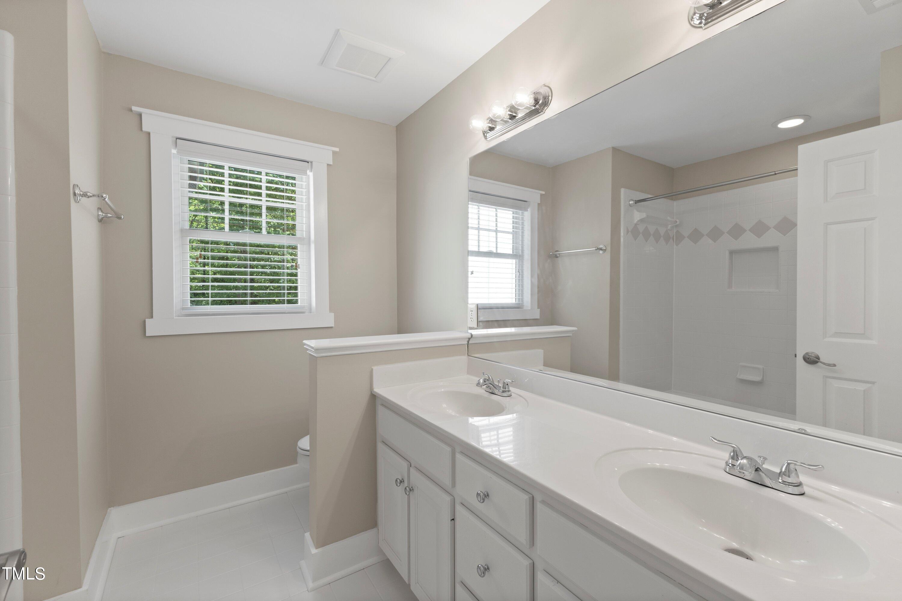 7408 Lakefall Drive Wake Forest, NC 27587 - Photo 39 of 65 a bathroom with a sink a toilet and shower