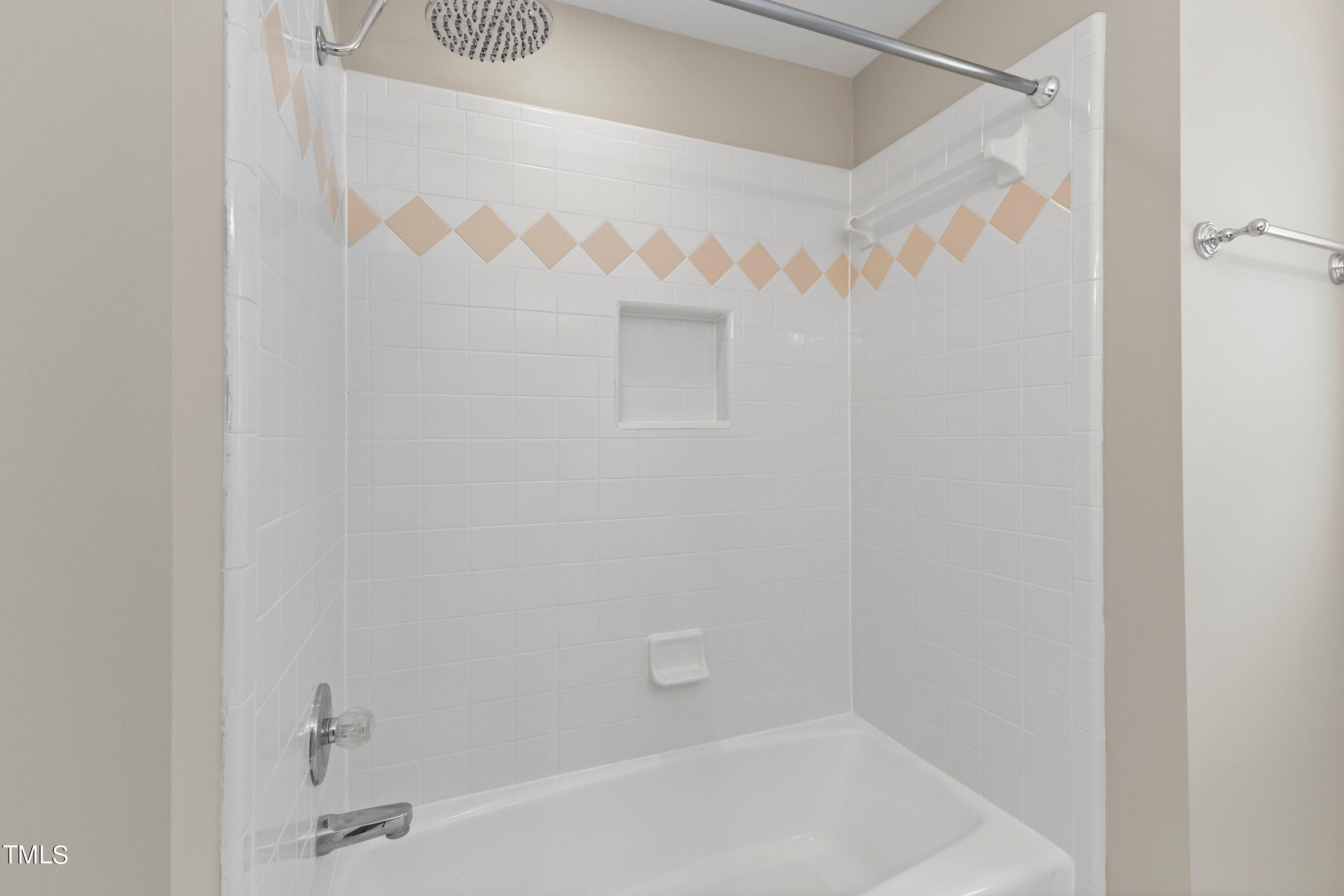 7408 Lakefall Drive Wake Forest, NC 27587 - Photo 40 of 65 a bathroom with a bathtub and a shower