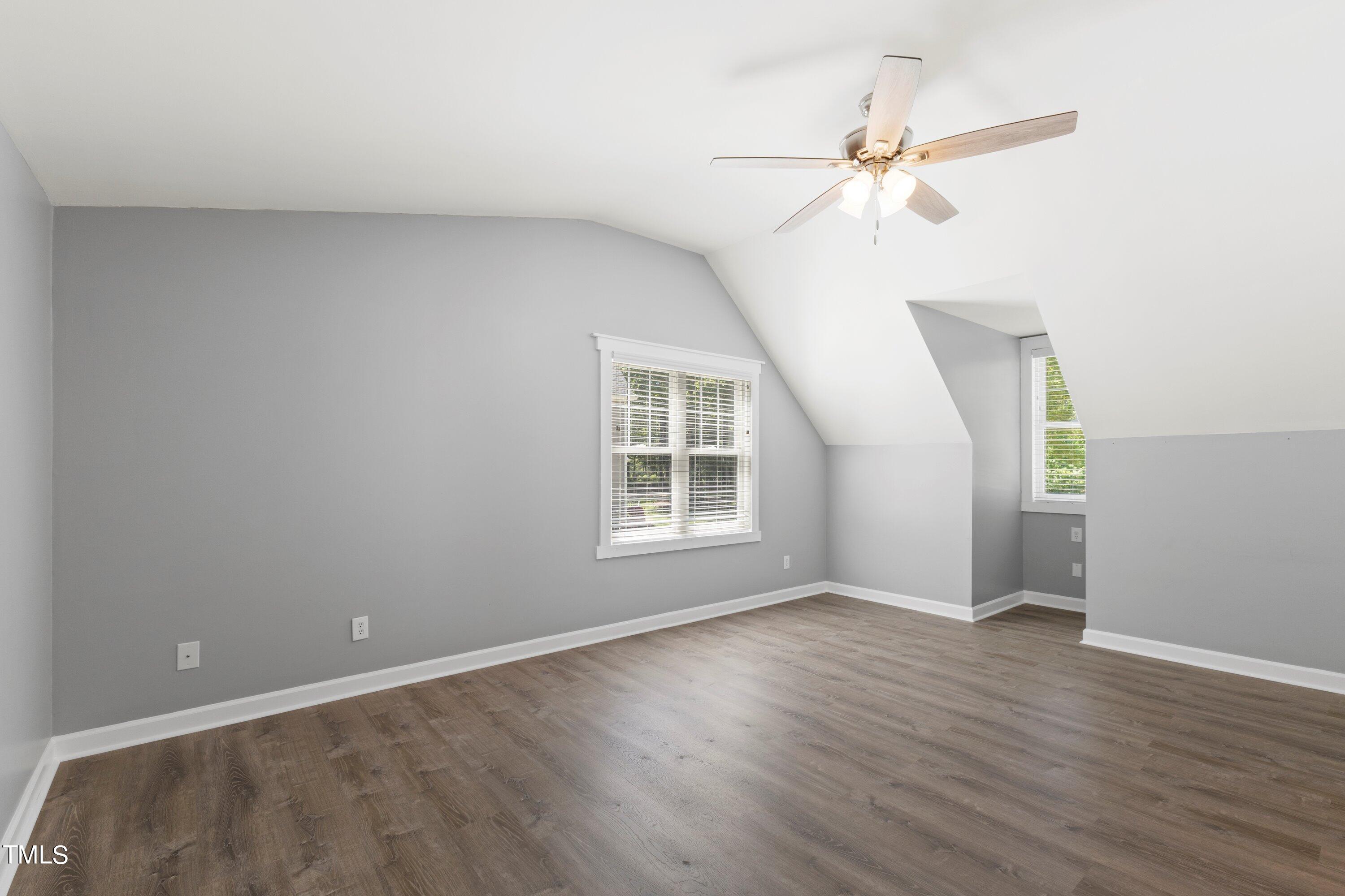 7408 Lakefall Drive Wake Forest, NC 27587 - Photo 42 of 65 a view of an empty room with wooden floor and a window