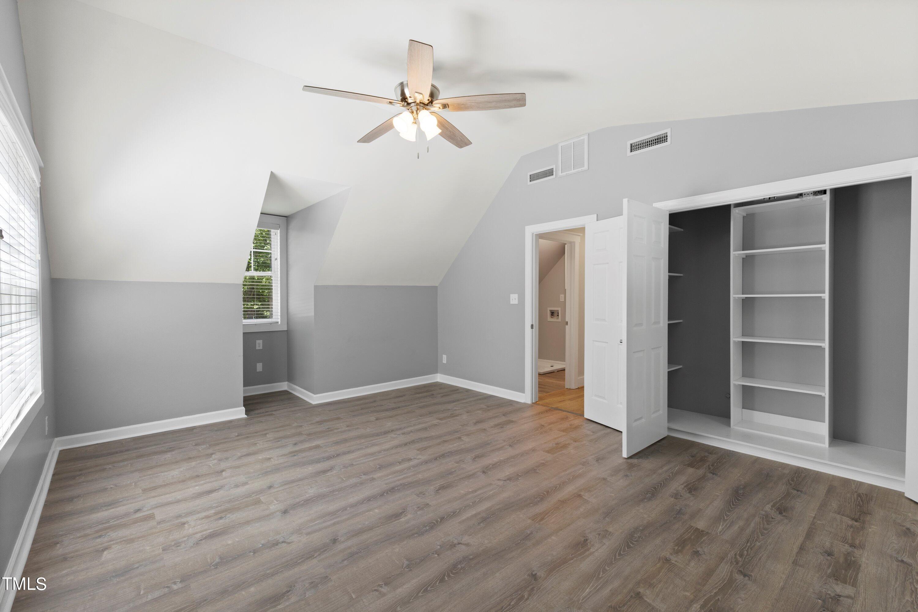 7408 Lakefall Drive Wake Forest, NC 27587 - Photo 43 of 65 an empty room with wooden floor closet and windows