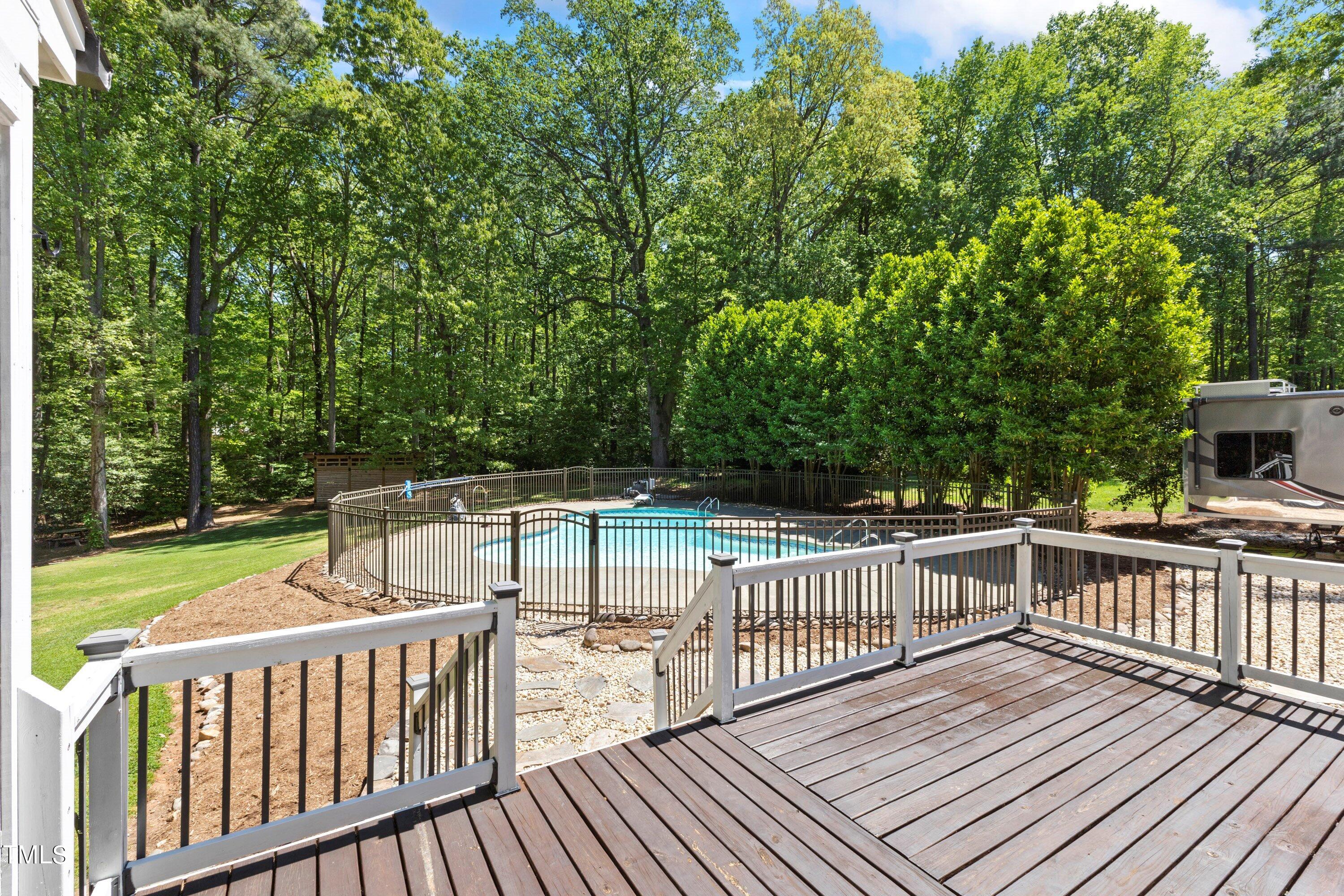 7408 Lakefall Drive Wake Forest, NC 27587 - Photo 49 of 65 a view of a deck with two chairs and wooden floor