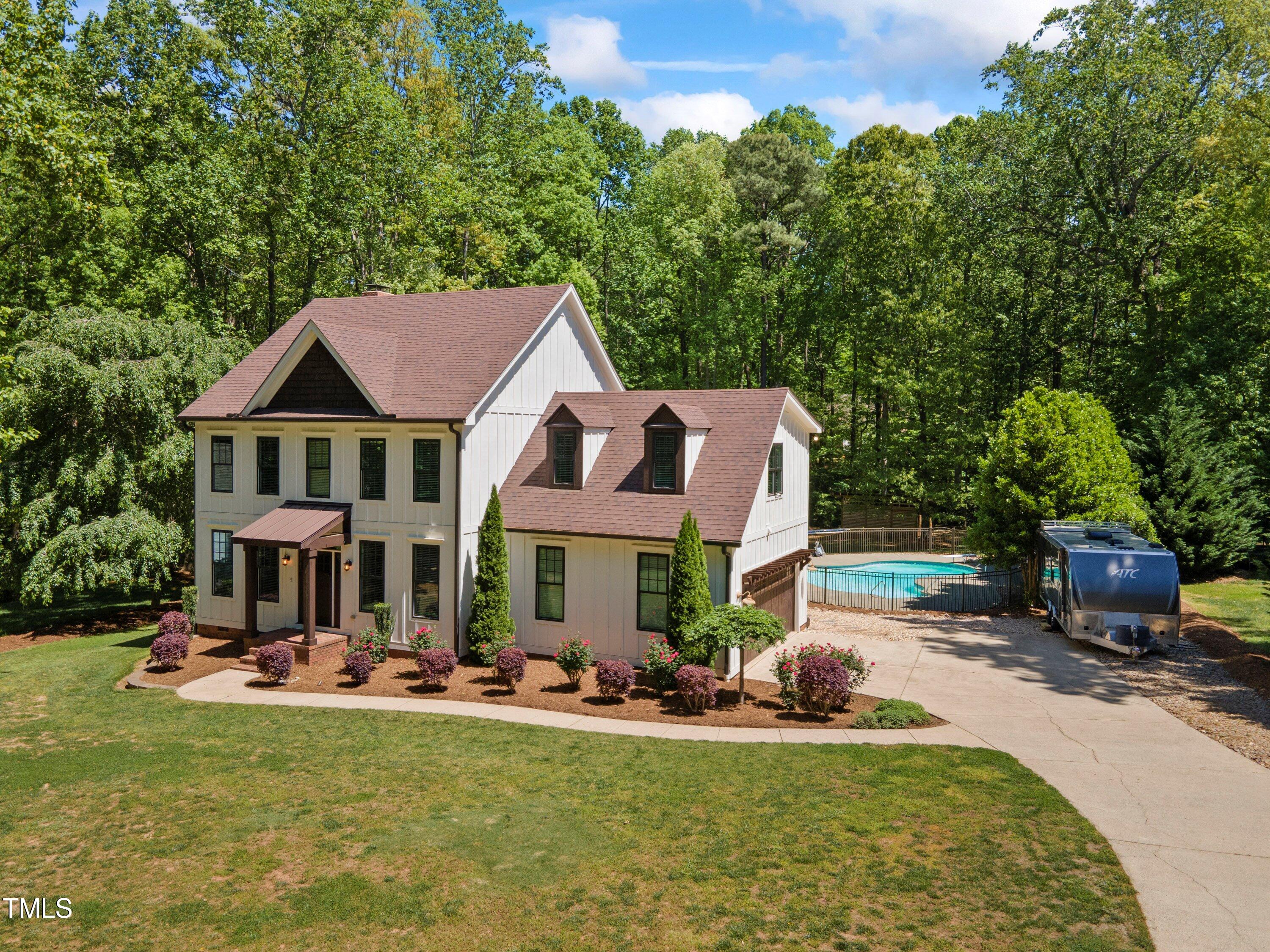 7408 Lakefall Drive Wake Forest, NC 27587 - Photo 5 of 65 a front view of a house with swimming pool having outdoor seating