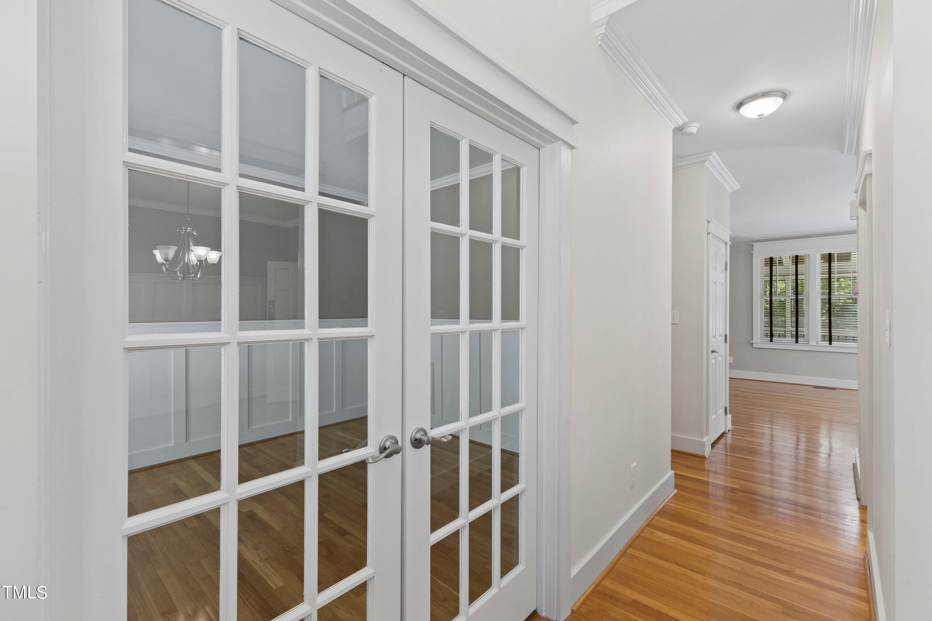7408 Lakefall Drive Wake Forest, NC 27587 - Photo 8 of 65 a view of an empty room with wooden floor and windows