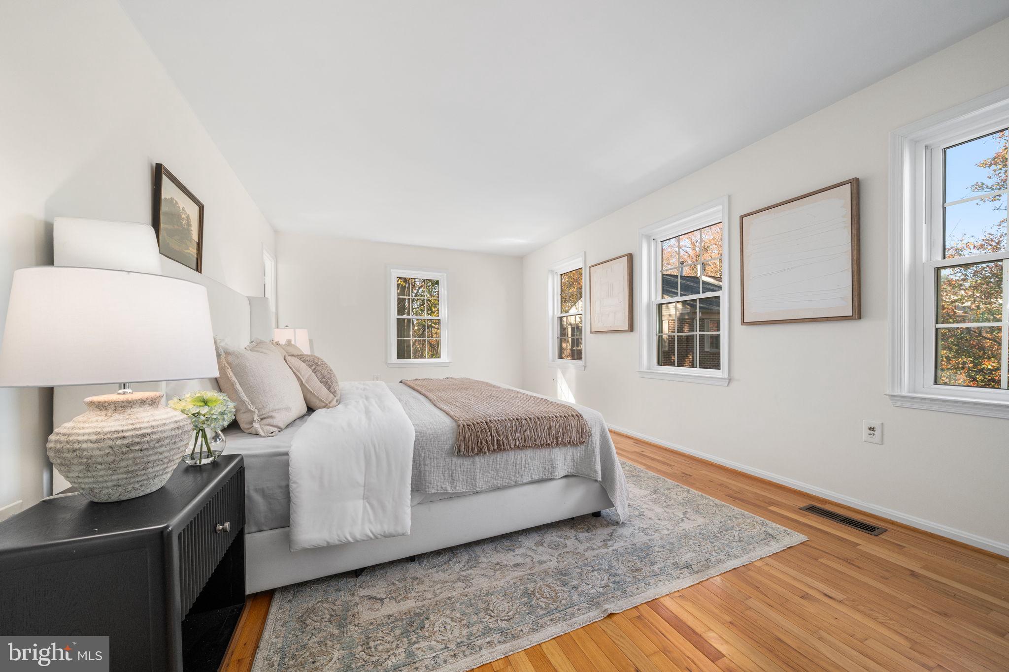 5658 Sutherland Court Burke, VA 22015 - Photo 13 of 30 a bedroom with a bed and wooden floor