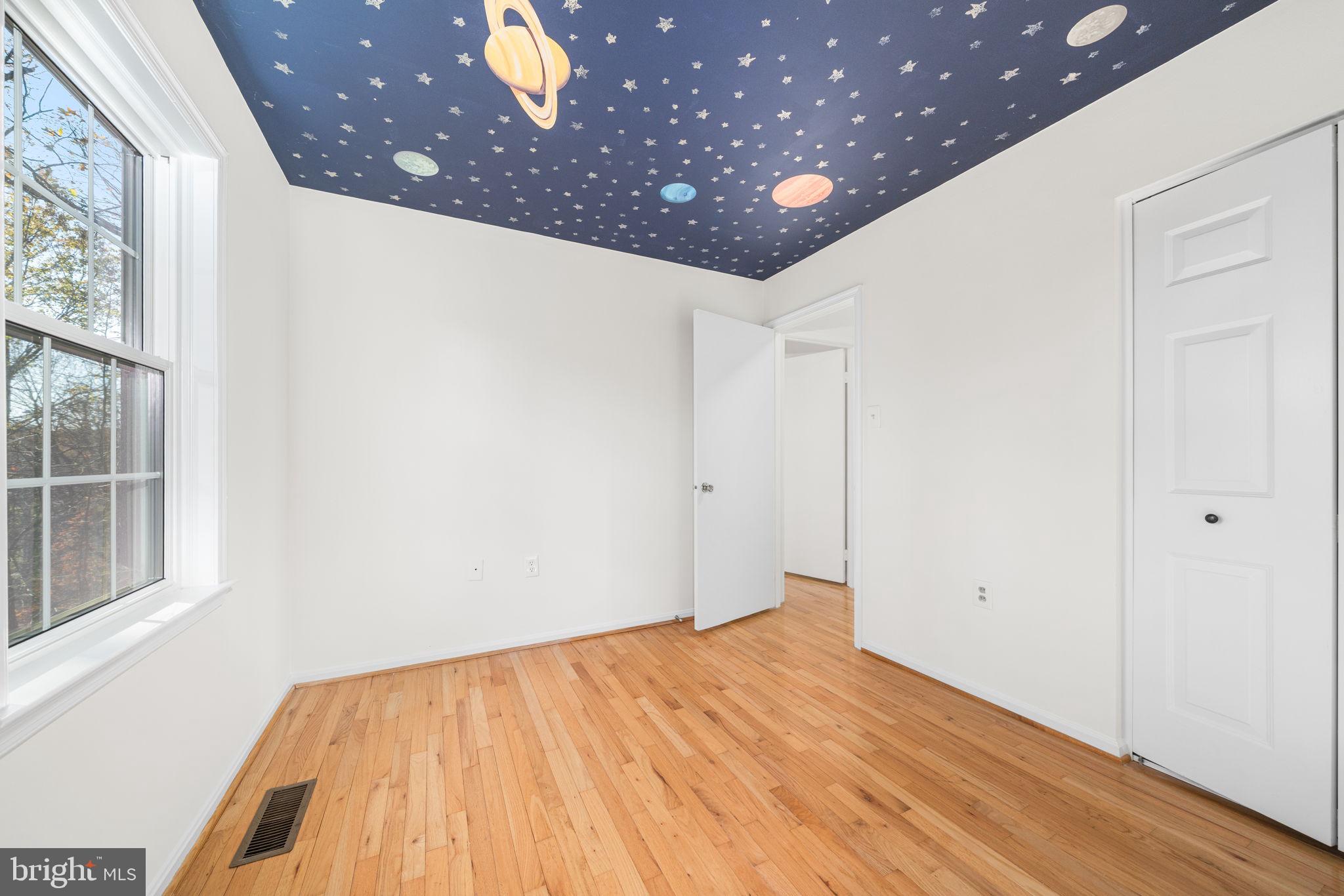 5658 Sutherland Court Burke, VA 22015 - Photo 16 of 30 a view of empty room with wooden floor and fan