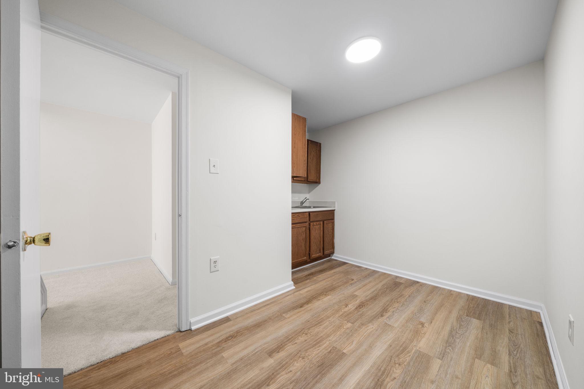 5658 Sutherland Court Burke, VA 22015 - Photo 22 of 30 a view of empty room with wooden floor