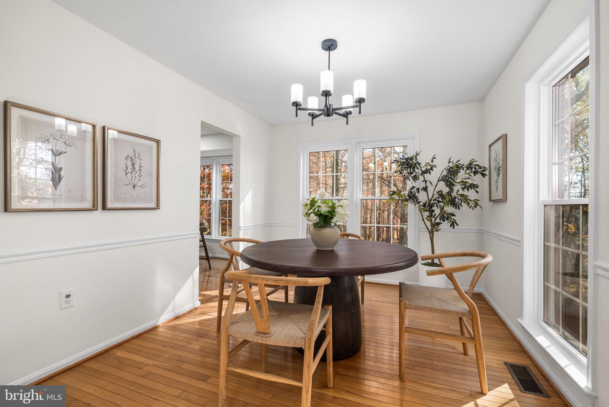 5658 Sutherland Court Burke, VA 22015 - Photo 6 of 30 a view of a dining room with furniture and wooden floor