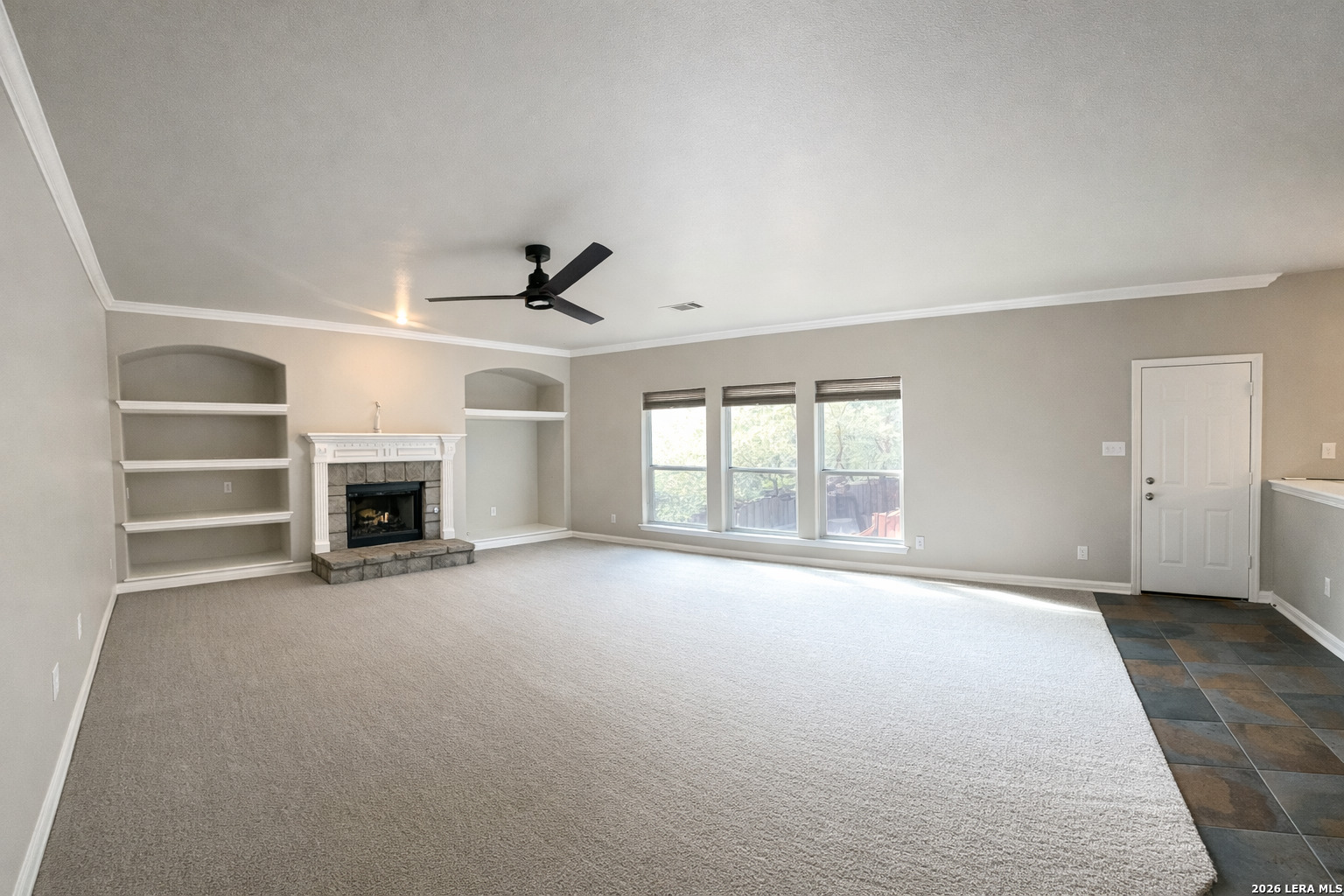 15603 Luna Ridge Helotes, TX 78023 - Photo 17 of 24 an empty room with fireplace and windows