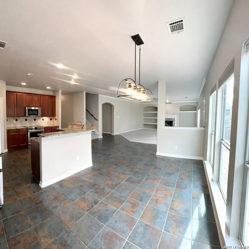 15603 Luna Ridge Helotes, TX 78023 - Photo 18 of 24 a view of a kitchen with a sink stainless steel appliances and cabinets