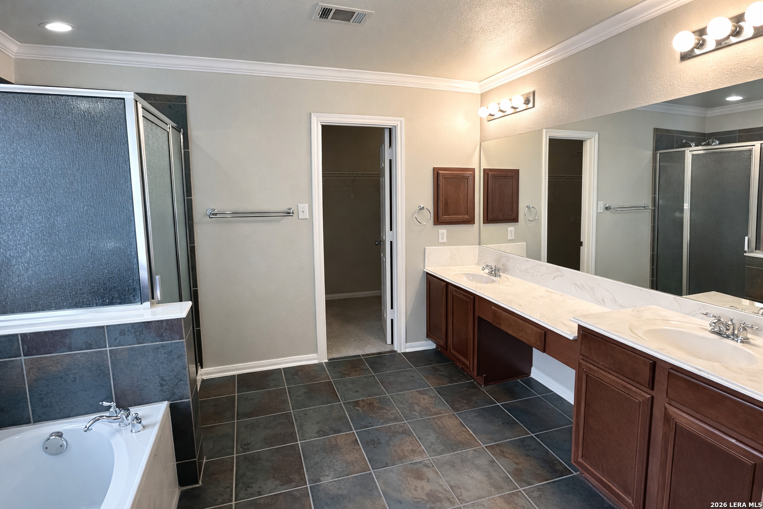 15603 Luna Ridge Helotes, TX 78023 - Photo 22 of 24 a spacious bathroom with a tub sink and mirror