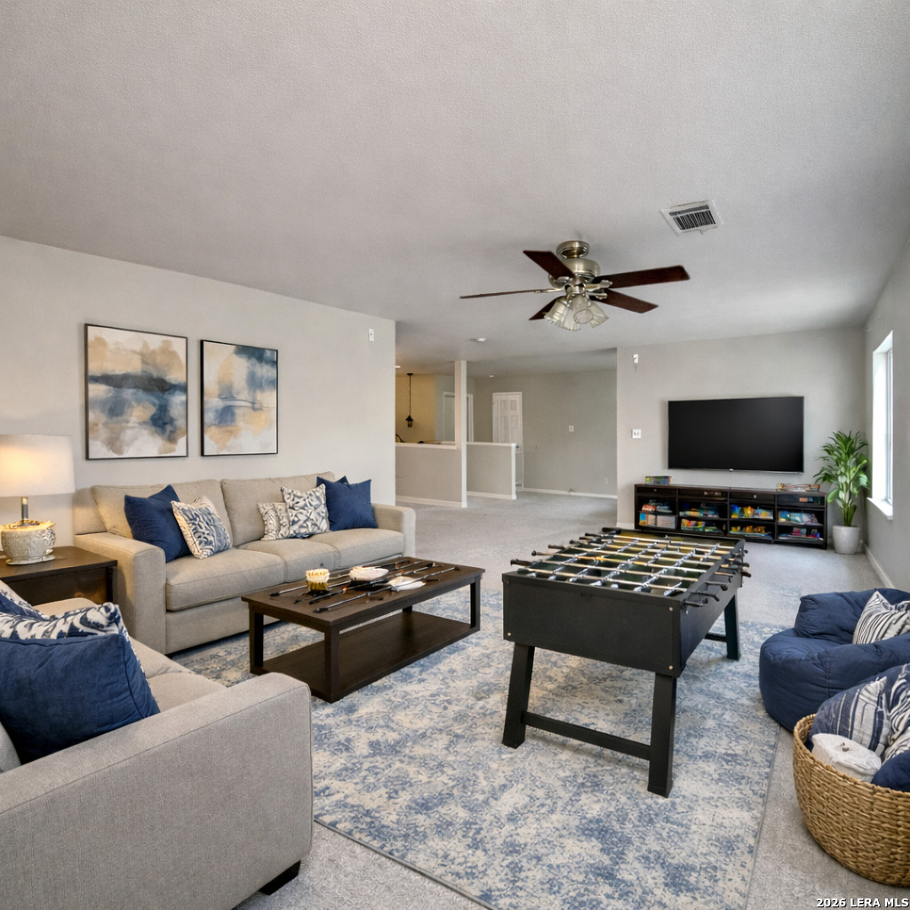 15603 Luna Ridge Helotes, TX 78023 - Photo 6 of 24 a living room with furniture a flat screen tv and a window