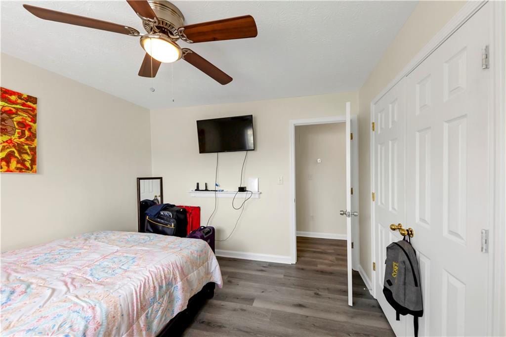 2880 Field Spring Drive Lithonia, GA 30058 - Photo 19 of 31 a bedroom with a bed and a flat screen tv