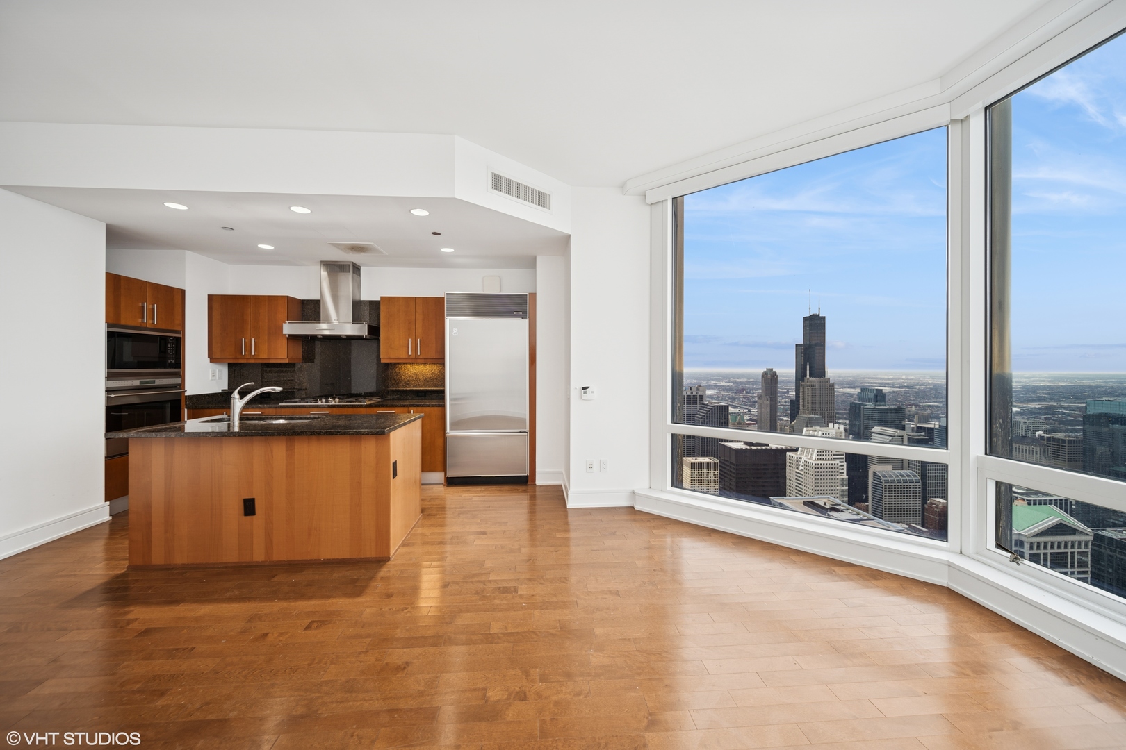 401 North Wabash Avenue, Unit 76G Chicago, IL 60611 - Photo 2 of 15 a open kitchen with granite countertop a refrigerator and a sink