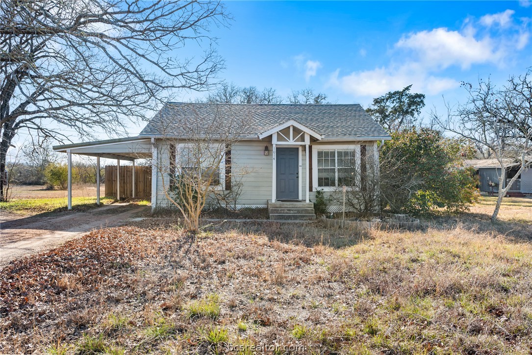 Bungalow-style house featuring a carport and driveway