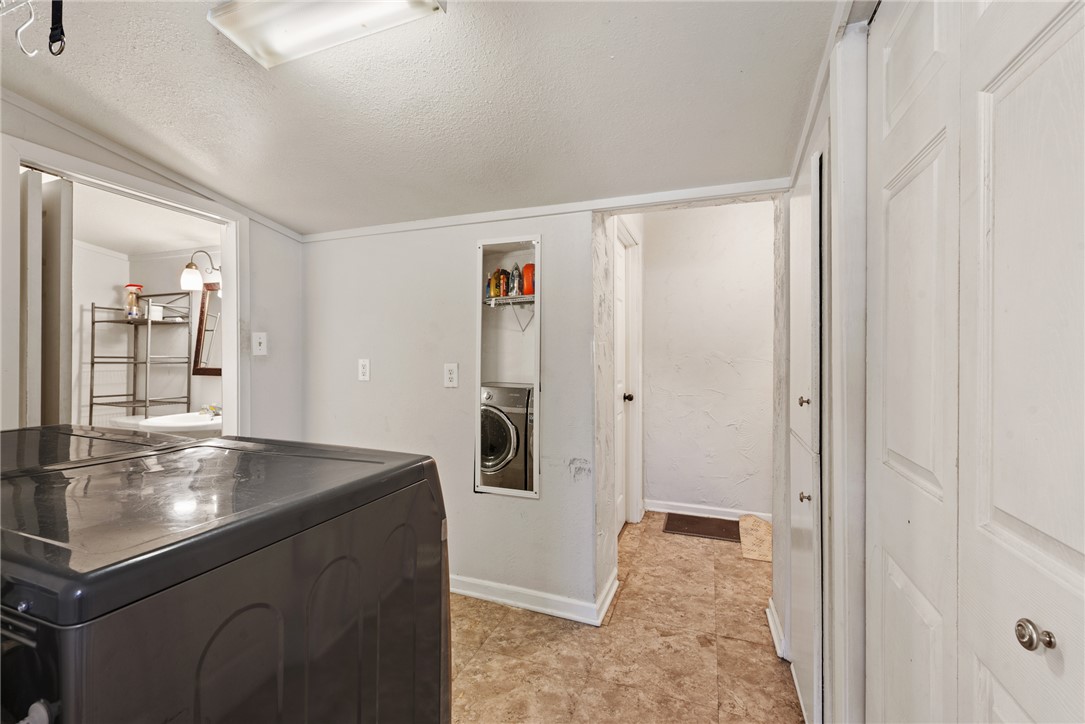 1014 Suncrest Street Bryan, TX 77803 - Photo 10 of 20 Laundry with washer / clothes dryer and a textured ceiling