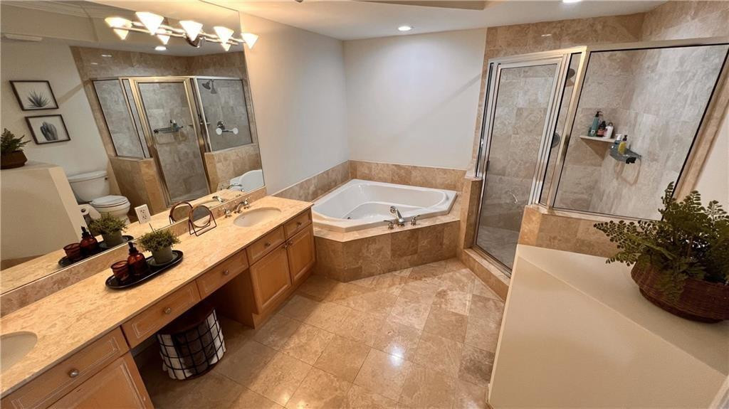 100 South Birch Road, Unit 1403F Fort Lauderdale, FL 33316 - Photo 24 of 31 a bathroom with a tub sink and mirror