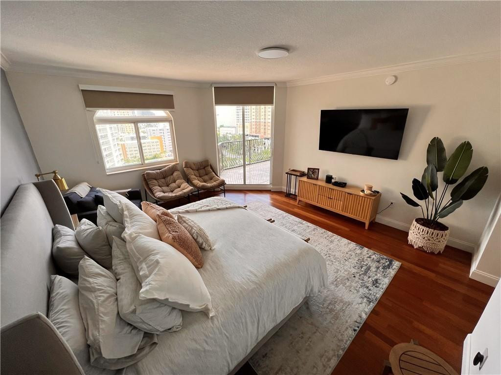 100 South Birch Road, Unit 1403F Fort Lauderdale, FL 33316 - Photo 26 of 31 a bedroom with a bed and a flat screen tv