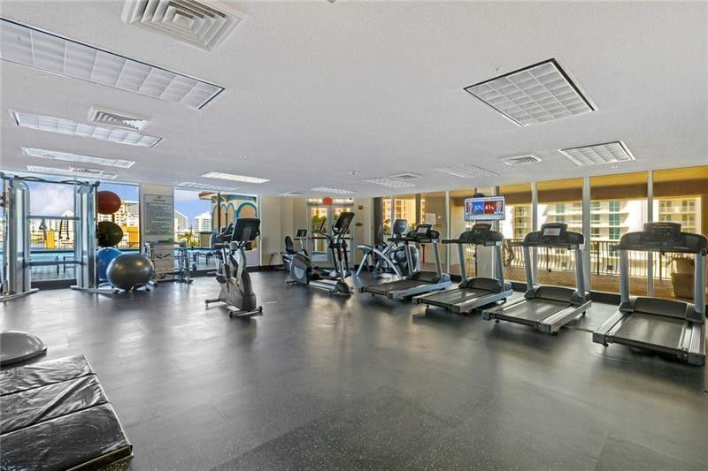 100 South Birch Road, Unit 1403F Fort Lauderdale, FL 33316 - Photo 5 of 31 a gym room with lots of furniture and a large window