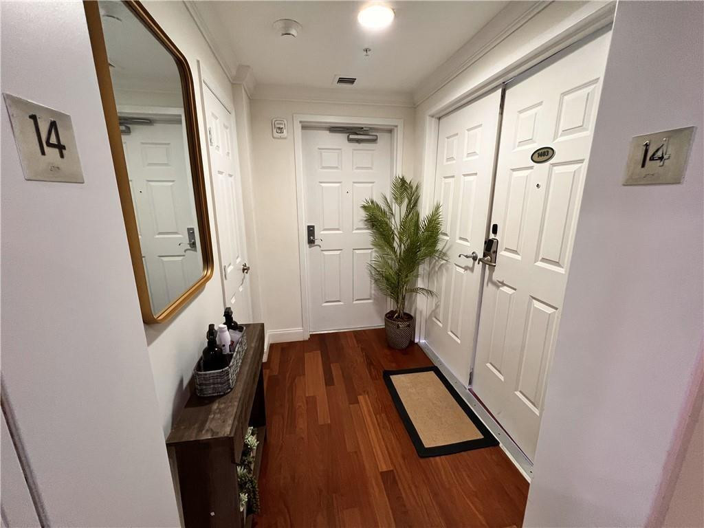 100 South Birch Road, Unit 1403F Fort Lauderdale, FL 33316 - Photo 8 of 31 a view of a hallway with wooden floor and staircase