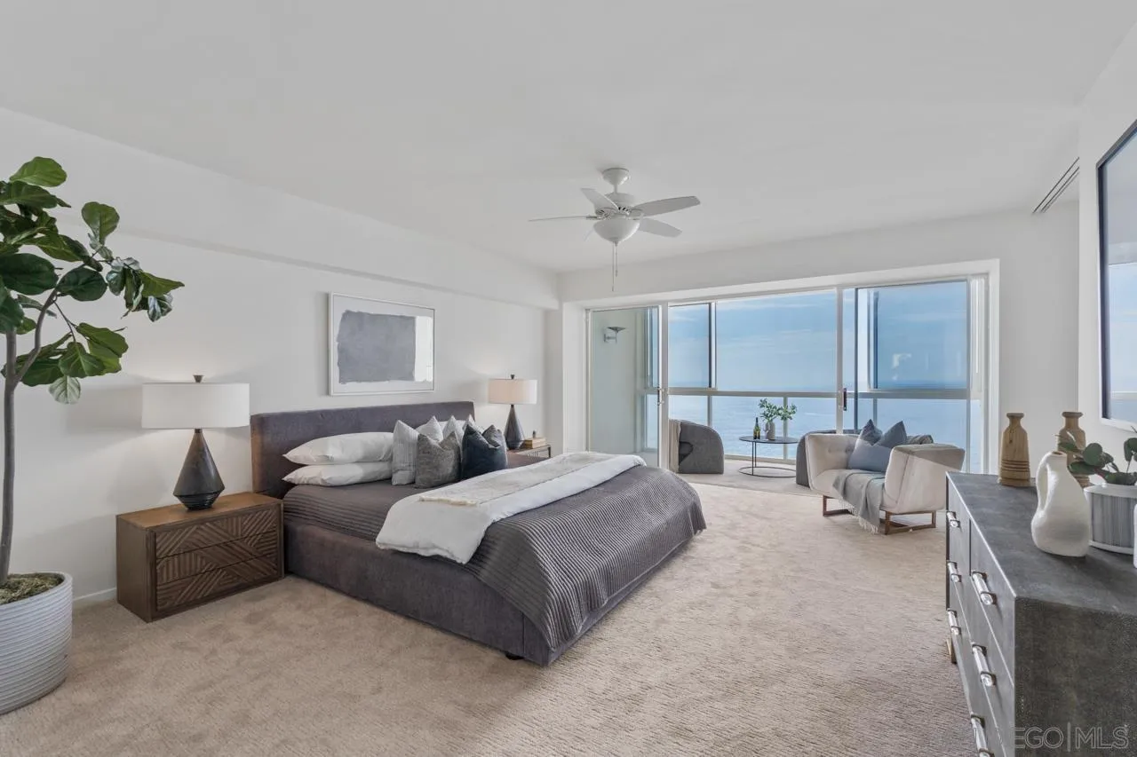 939 Coast Boulevard, Unit 20C La Jolla, CA 92037 - Photo 13 of 25 a spacious bedroom with a bed and a couch