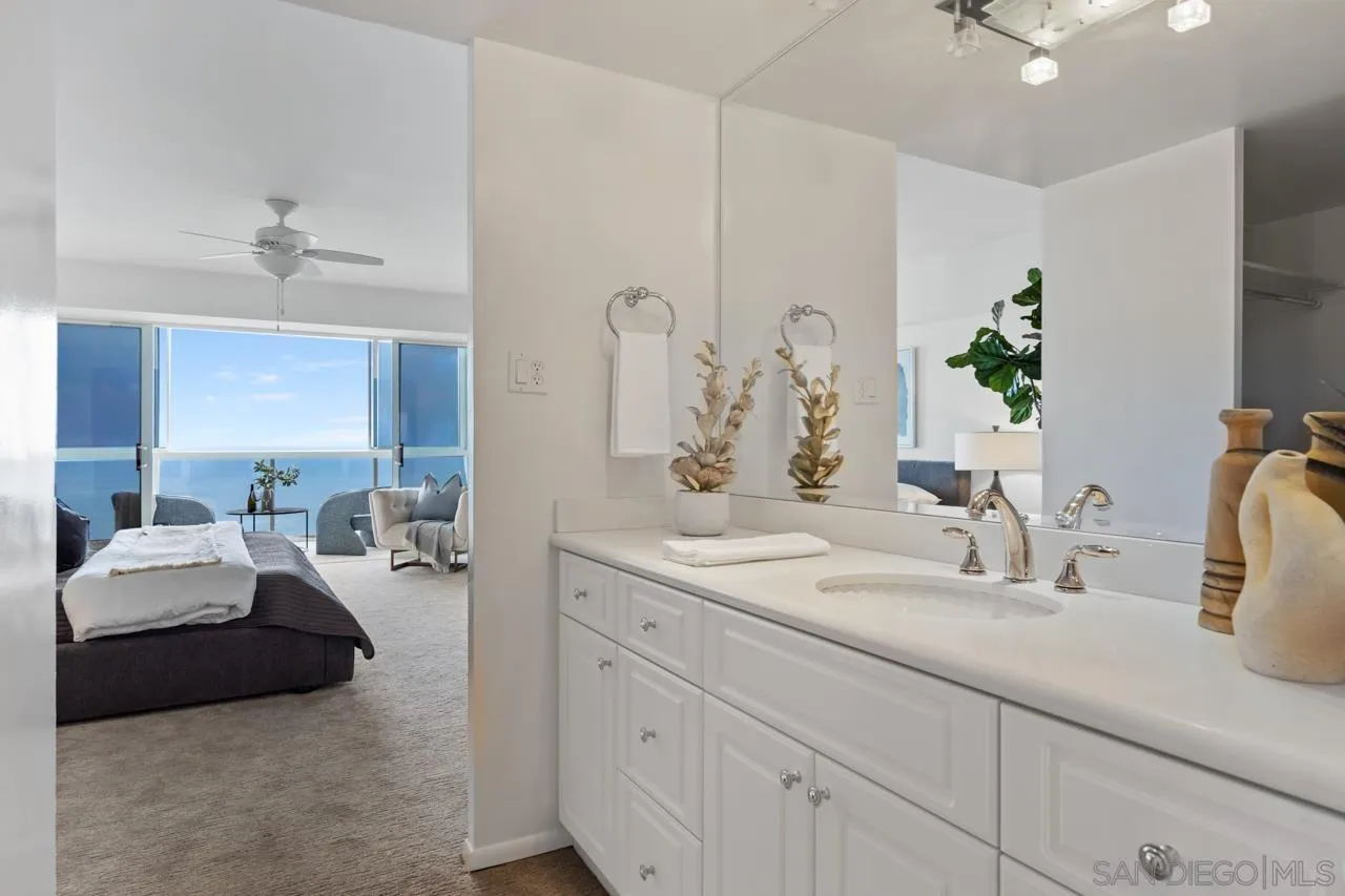 939 Coast Boulevard, Unit 20C La Jolla, CA 92037 - Photo 15 of 25 a en suite bathroom with a double vanity sink and a mirror