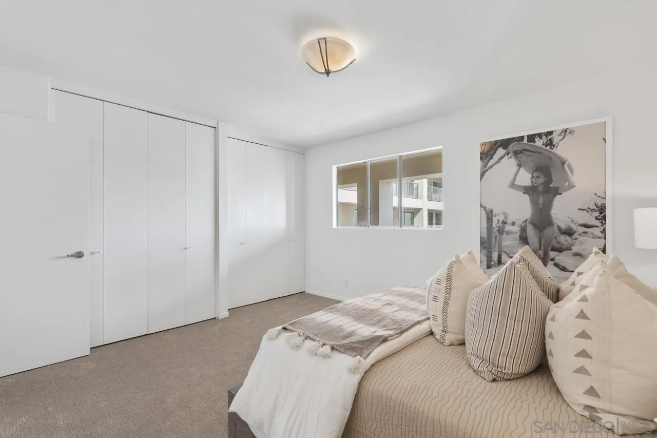 939 Coast Boulevard, Unit 20C La Jolla, CA 92037 - Photo 18 of 25 a bedroom with a bed and a window