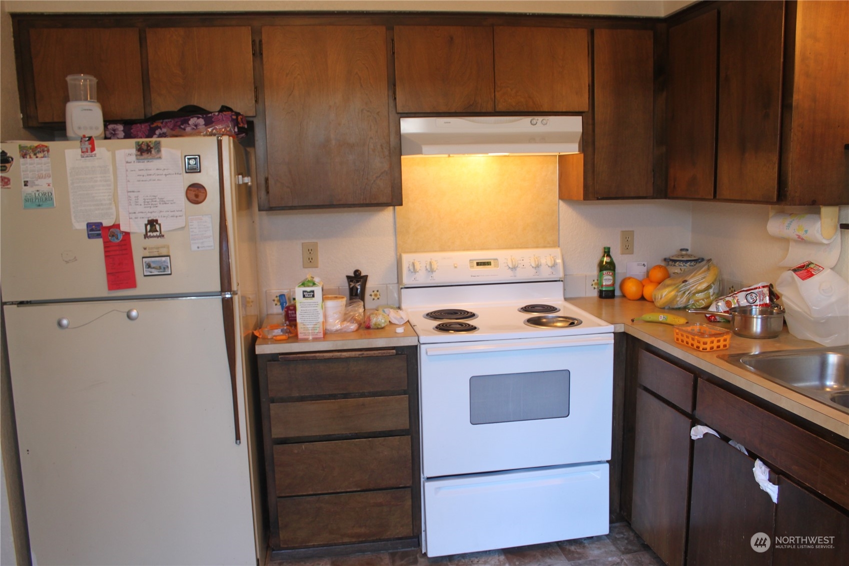1729 Madison Street Everett, WA 98203 - Photo 12 of 32 a kitchen with stainless steel appliances a stove a microwave and a refrigerator