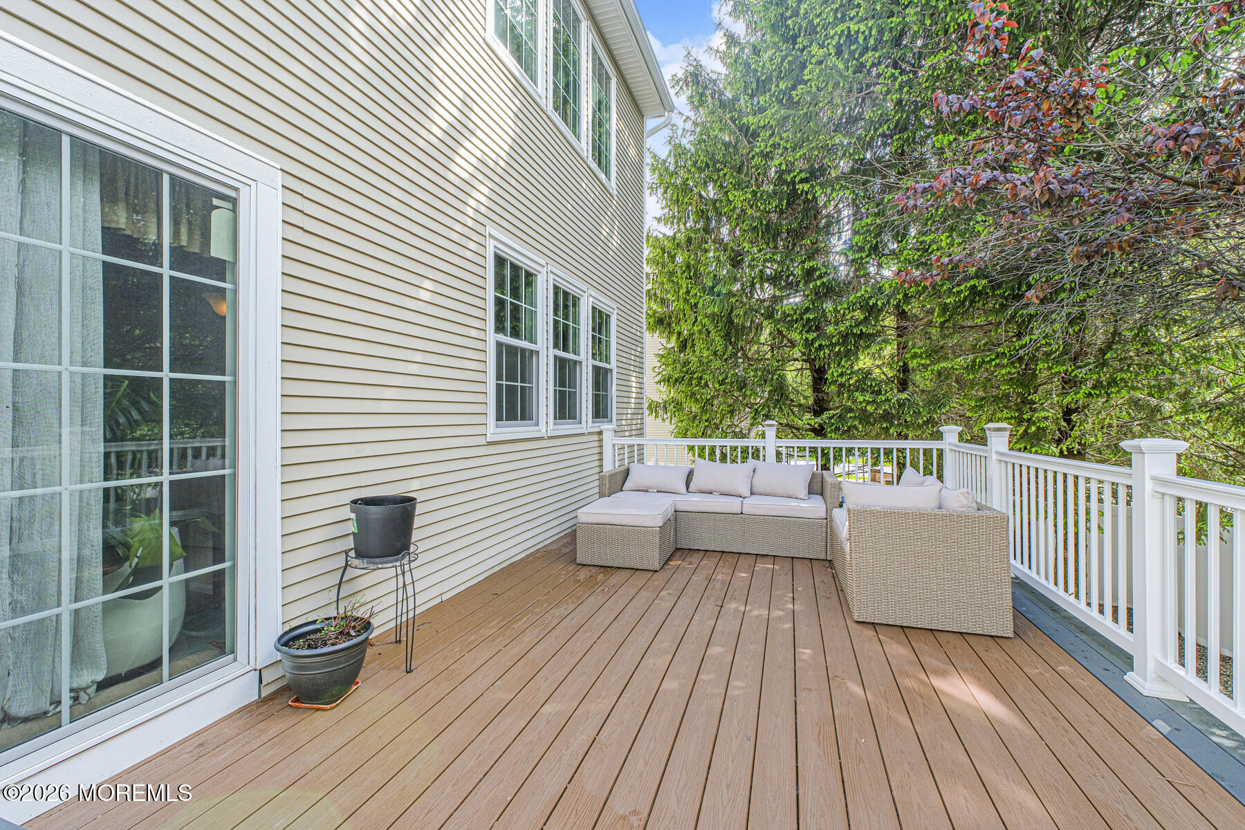315 Wedgewood Road Morganville, NJ 07751 - Photo 34 of 37 a view of a deck with couches wooden floor and fence