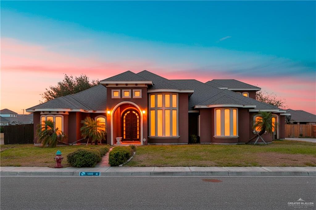 1502 Eucalyptus Street Weslaco, TX 78599 - Photo 1 of 24 a front view of a house with a yard