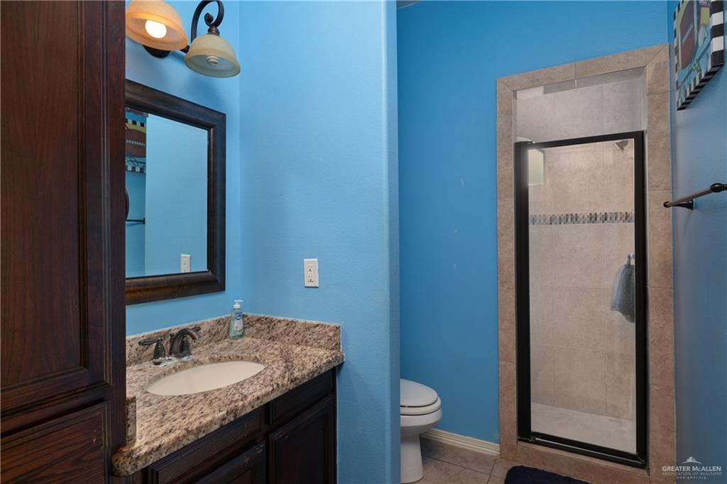 1502 Eucalyptus Street Weslaco, TX 78599 - Photo 14 of 24 a bathroom with a granite countertop sink and a mirror