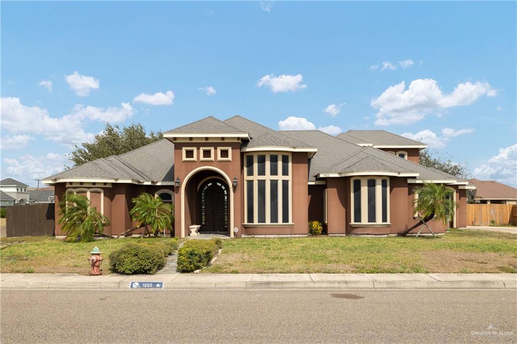 1502 Eucalyptus Street Weslaco, TX 78599 - Photo 2 of 24 a front view of a house with a garden