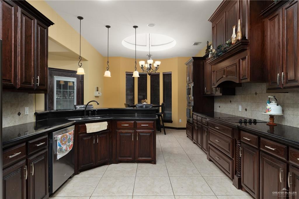 1502 Eucalyptus Street Weslaco, TX 78599 - Photo 6 of 24 a kitchen with a sink and cabinets
