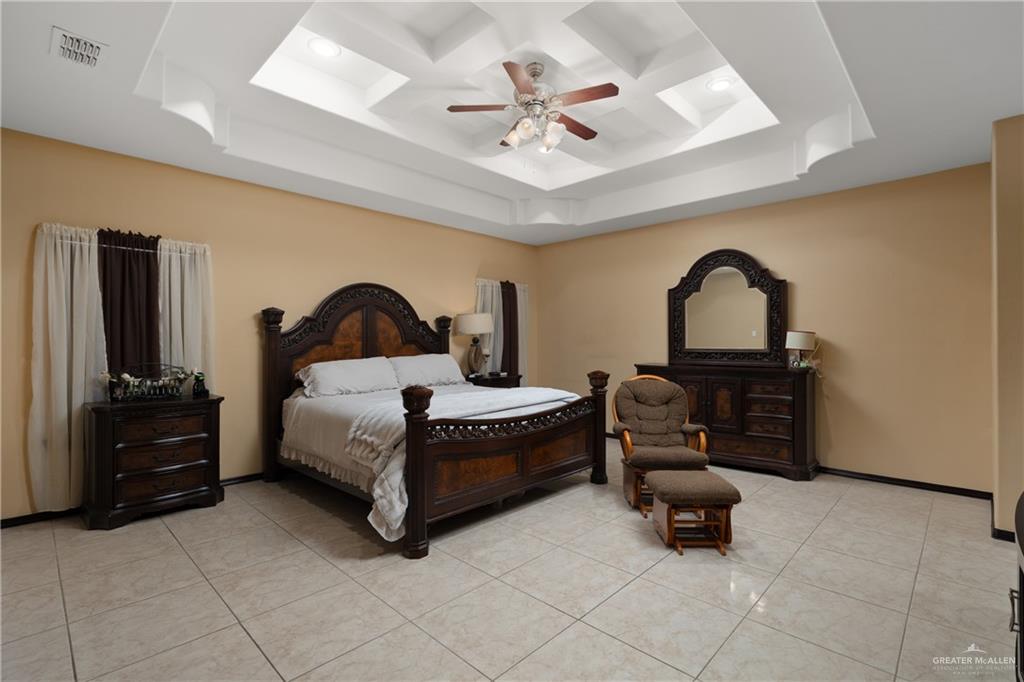 1502 Eucalyptus Street Weslaco, TX 78599 - Photo 9 of 24 a spacious bedroom with a bed and a dresser