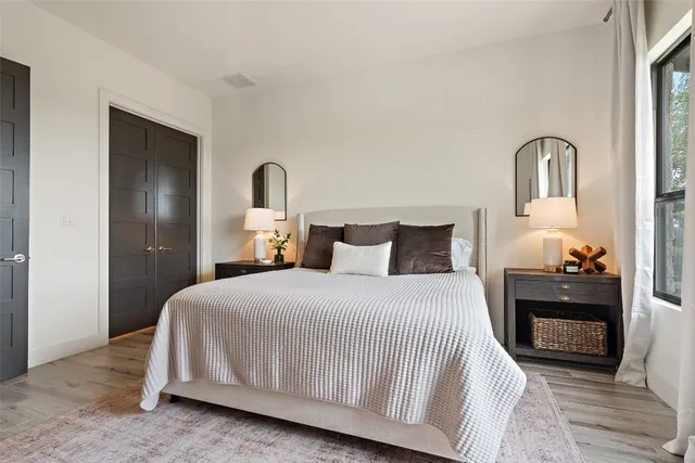 a bedroom with a large bed and a window