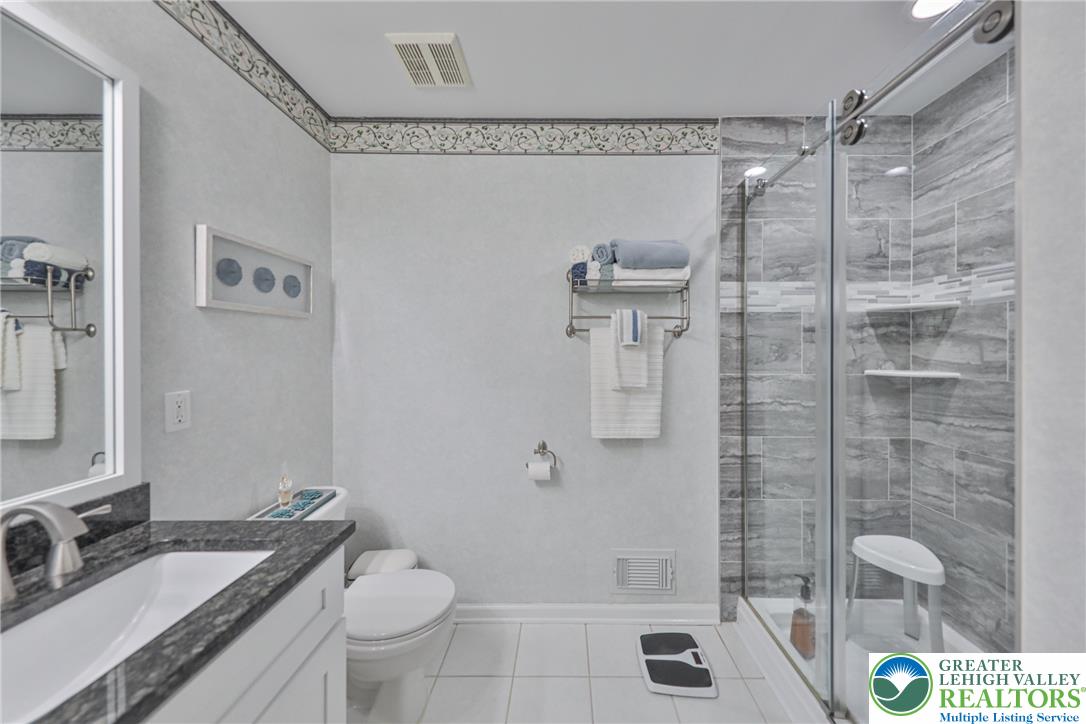 163 Muirfield Way Easton, PA 18042 - Photo 23 of 48 a bathroom with a granite countertop sink toilet and shower
