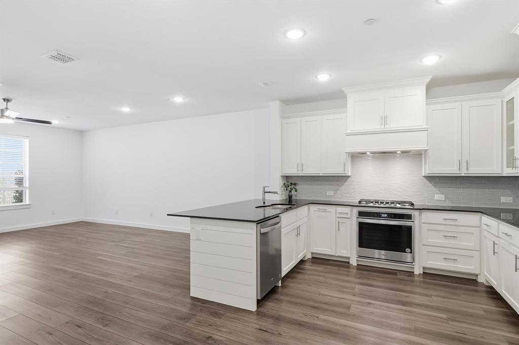 531 Cobblestone Lane Irving, TX 75039 - Photo 39 of 39 a kitchen with granite countertop a stove and a sink