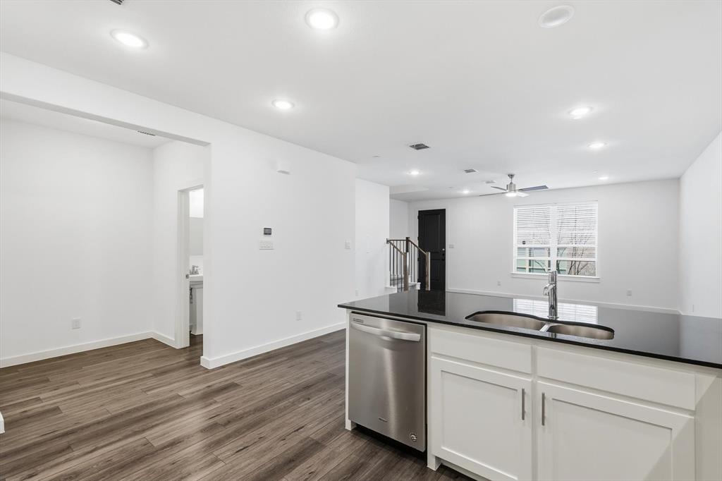 531 Cobblestone Lane Irving, TX 75039 - Photo 11 of 39 a kitchen with sink cabinets and wooden floor