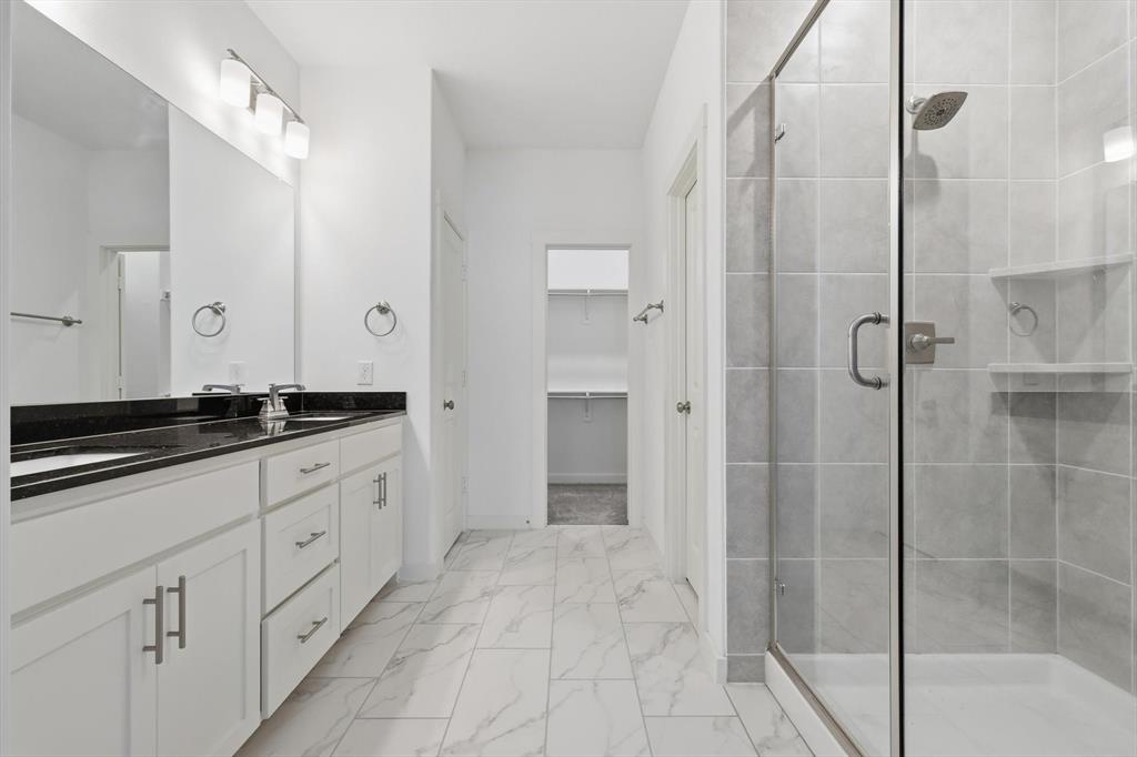 531 Cobblestone Lane Irving, TX 75039 - Photo 20 of 39 a spacious bathroom with a shower and a sink
