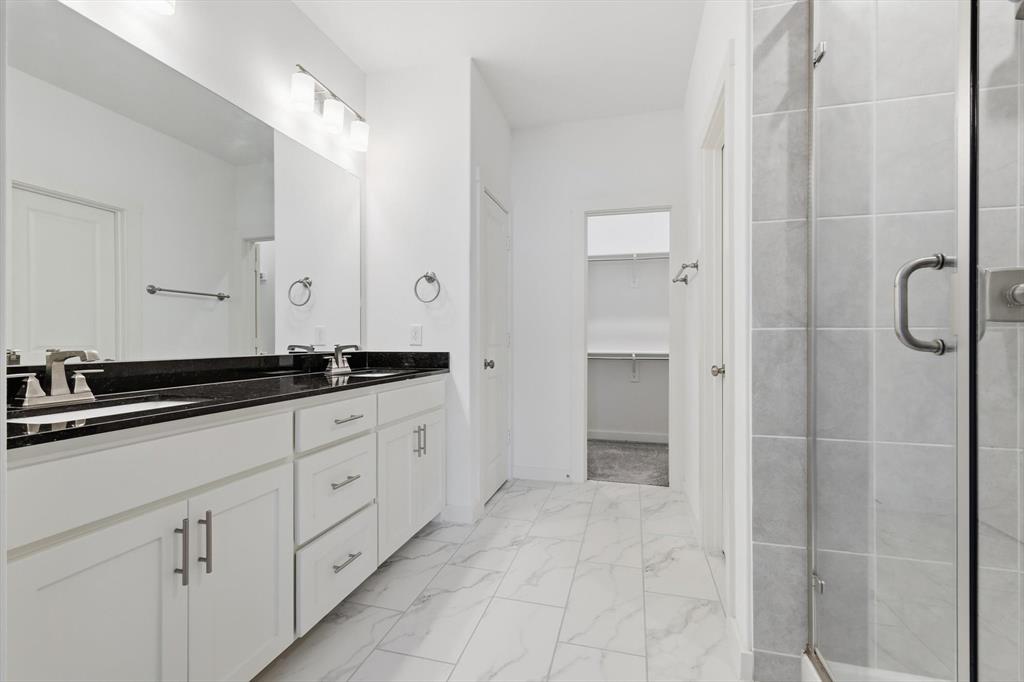 531 Cobblestone Lane Irving, TX 75039 - Photo 21 of 39 a bathroom with a double vanity sink and mirror