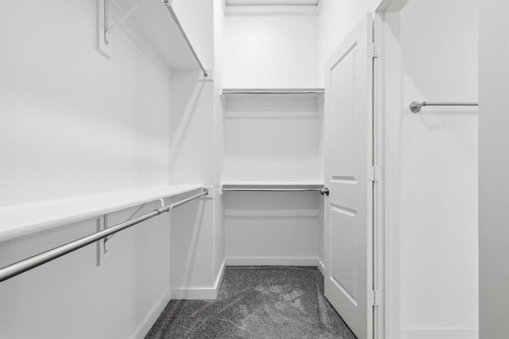 531 Cobblestone Lane Irving, TX 75039 - Photo 23 of 39 a view of walk in closet with empty racks