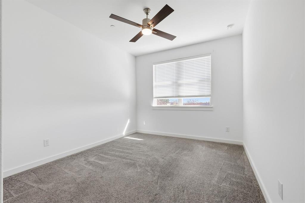 531 Cobblestone Lane Irving, TX 75039 - Photo 30 of 39 an empty room with a window and a fan