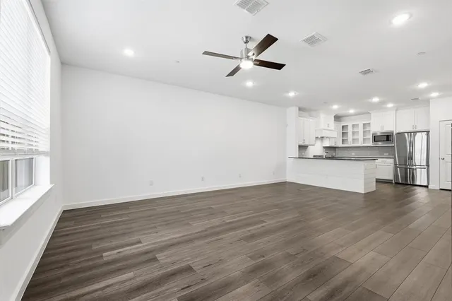 a view of a kitchen with a dishwasher cabinets and wooden floor