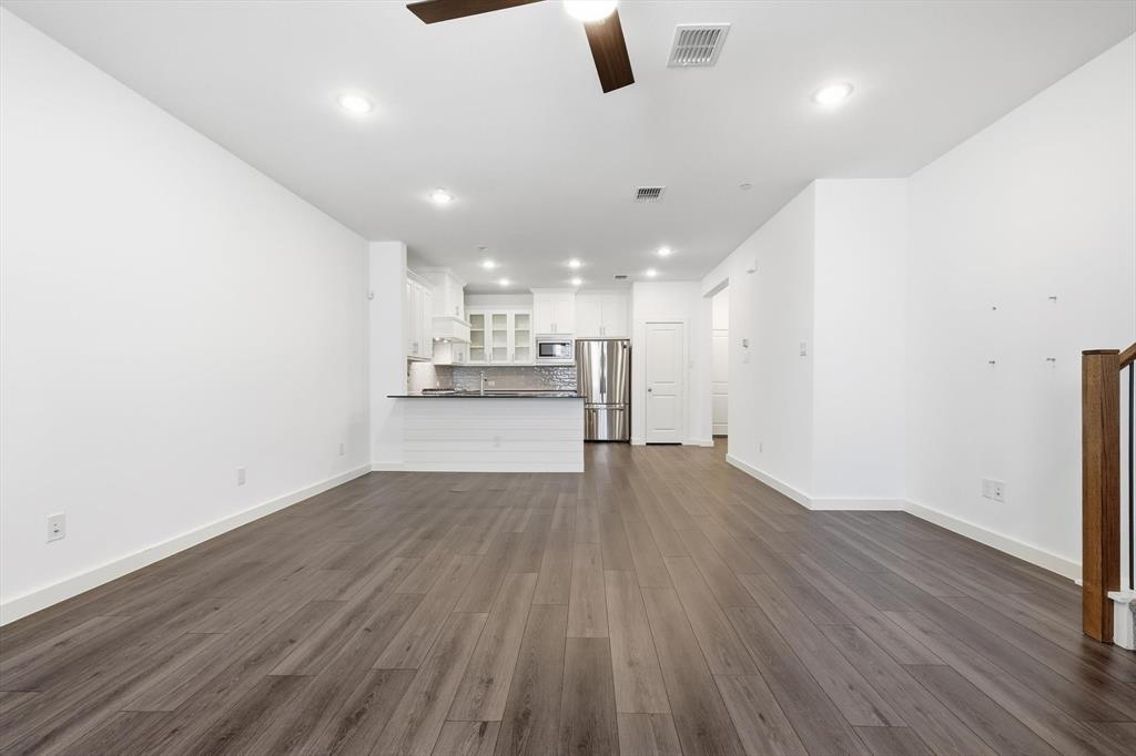 531 Cobblestone Lane Irving, TX 75039 - Photo 5 of 39 an empty room with wooden floor and windows