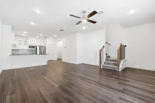 a view of a kitchen and wooden floor