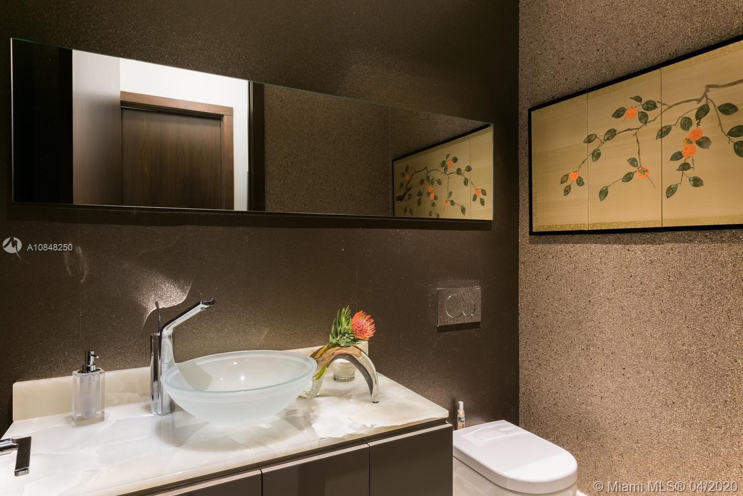 810 Jeronimo Drive Coral Gables, FL 33146 - Photo 13 of 32 a bathroom with a toilet sink and mirror