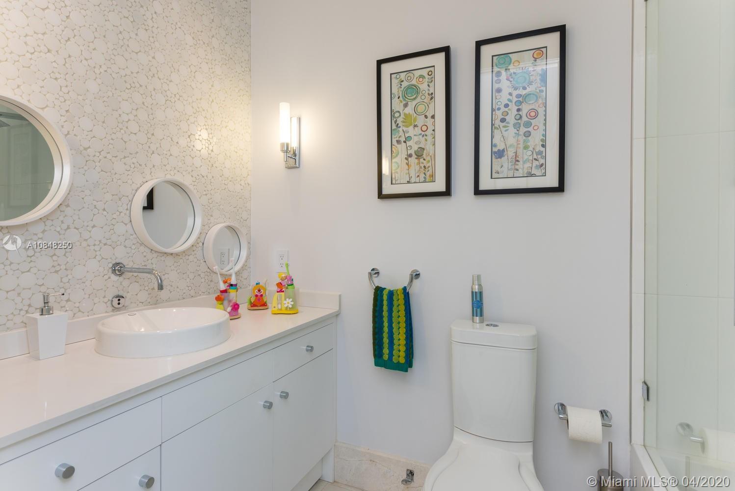 810 Jeronimo Drive Coral Gables, FL 33146 - Photo 15 of 32 a bathroom with a sink mirror and toilet