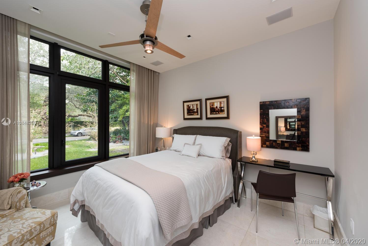 810 Jeronimo Drive Coral Gables, FL 33146 - Photo 16 of 32 a bedroom with a large bed and a balcony