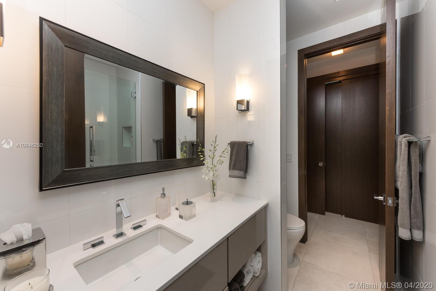 810 Jeronimo Drive Coral Gables, FL 33146 - Photo 17 of 32 a bathroom with a sink and a mirror